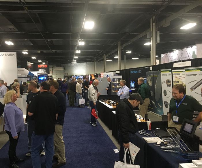 Attendees navigate various booths at Eastec 2019. 