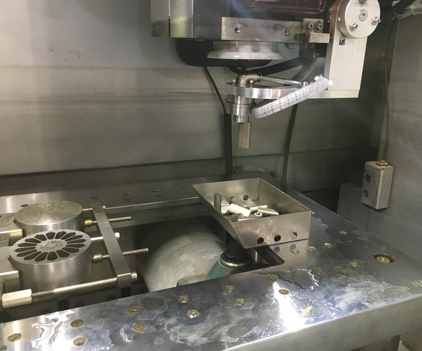 The automatic slug removal system pulls a cut piece of metal from the workpiece on an AgieCharmilles Cut P 350 EDM from GF Machining Solutions. 
