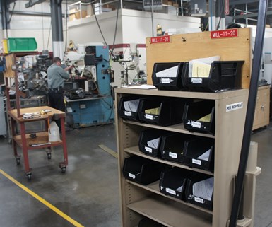 Black bins hold work-in-process (WIP) at Ohio machine shop Northwood Industries. 