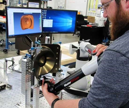 ake Blankenship, a quality inspector at Flying S in Palestine, Illinois, measures a machined part with a portable CMM arm. 