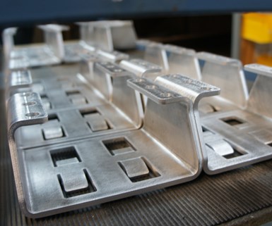 A set of brackets machined via waterjet and press brake at composites manufacturer DeltaWing. 