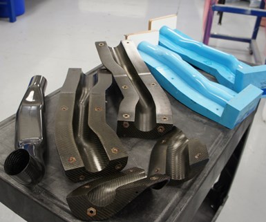 This CFRP ducting component (left) was cured in a CFRP mold (middle) created from an epoxy pattern (right).