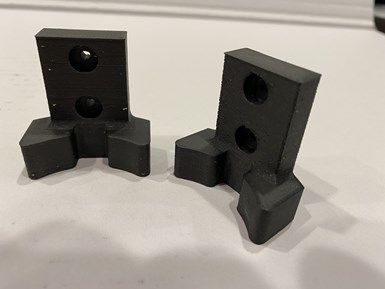 Two parts of a 3D-printed custom robot gripper for tending CNC machining centers are laid out on the table at Advanced Precision Engineering (APE).