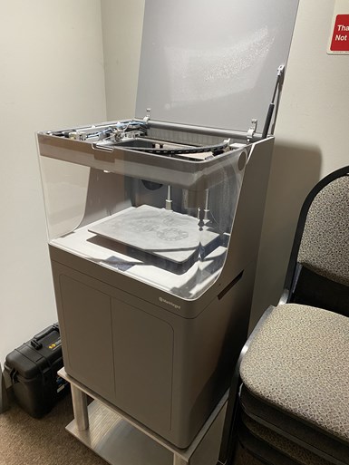 A Markforged X7 3D printer sits in an office at Advanced Precision Engineering (APE).  