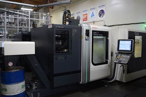 A metal part undergoes CNC operations on a Makino A500Z five-axis machining center. 