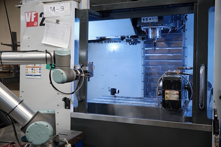A collaborative robot arm loads and unloads quick-change fixturing devices on a vertical machining center. 