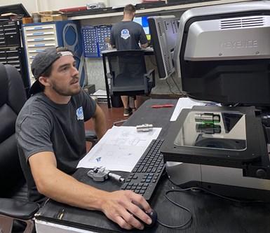 An employee at ACR Machine Co. measures a part on an optical inspection system. 