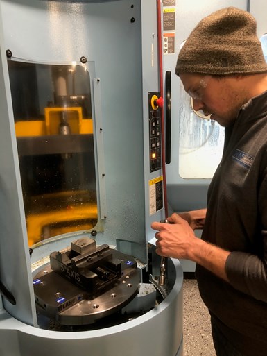 Kyle Szczypienski, founder and owner of KCS Advanced Machcining Services, sets up a pallet on one of the company’s new Matsuura five-axis machines.