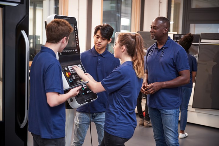 Students learning at a console.