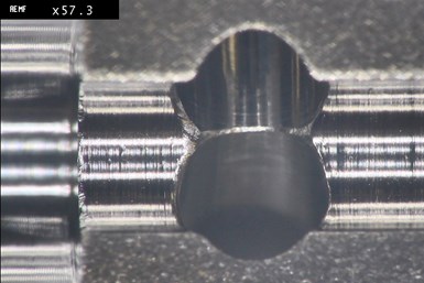 A zoomed-in photo of a cross hole in one of Paramount Machine's parts, now deburred through Orbitool.