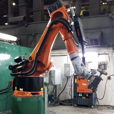 A large robot manipulates a large grinding wheel on the foundry floor at metal-forming equipment manufacturer Nidec-Minster. 