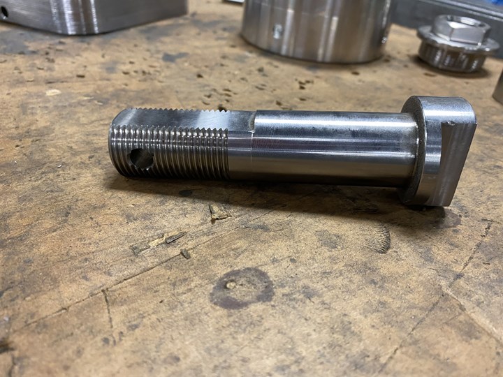 A stainless steel valve stem includes a number of flats, threads and other CNC-machined features. 