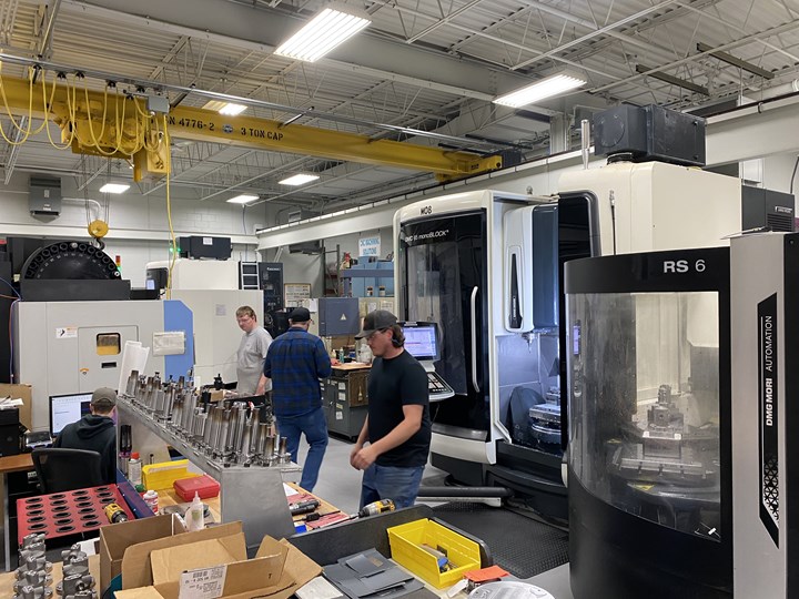Employees work with five-axis machining centers on the shop floor of KLH Industries. 