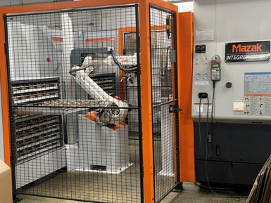A photo of MTH Pumps' six-axis robot in a cage next to its Integrex 200-IIIST