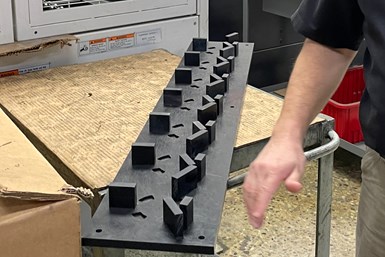 A photo of a custom gantry board, with raised feet in a repeating pattern down its length. 