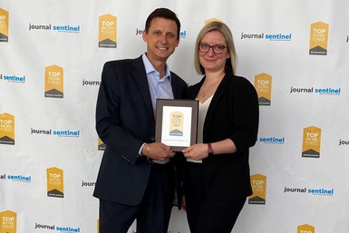 Two people holding award