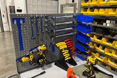 A workbench in BDE, with outlines of tools in blue where they should be stored.
