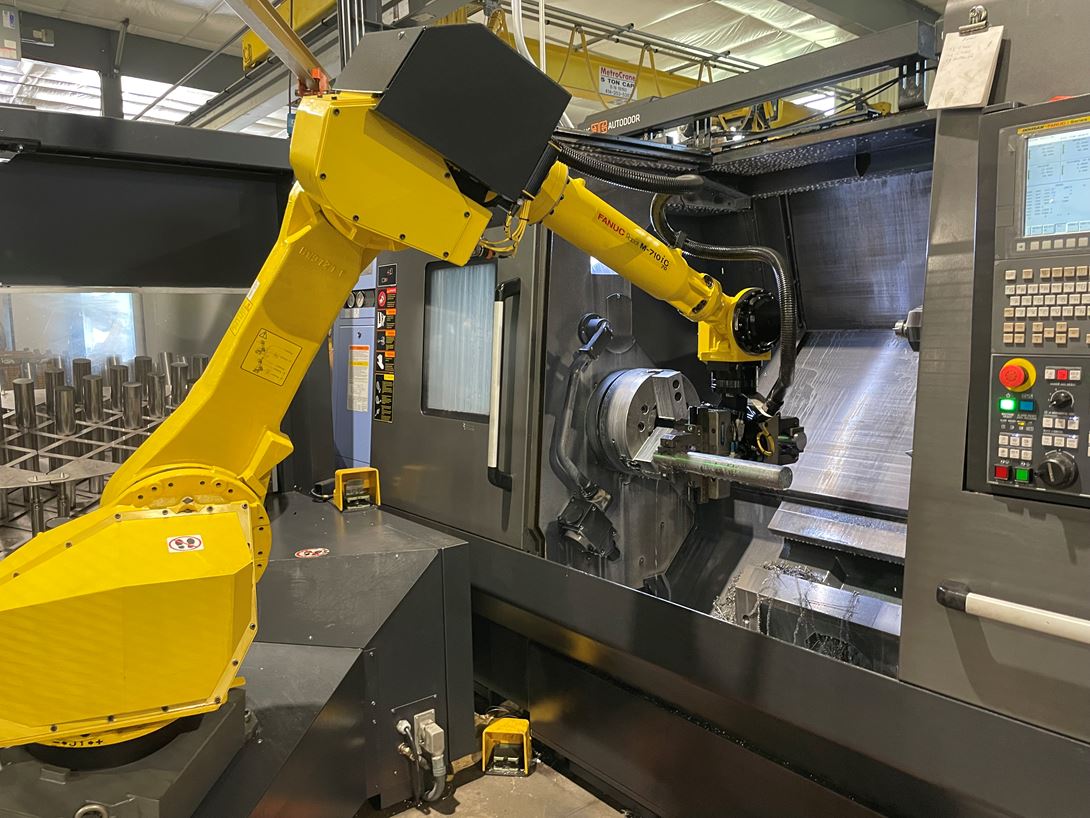 Robots and people performing operations in different areas of Pro Products Inc's shop floor