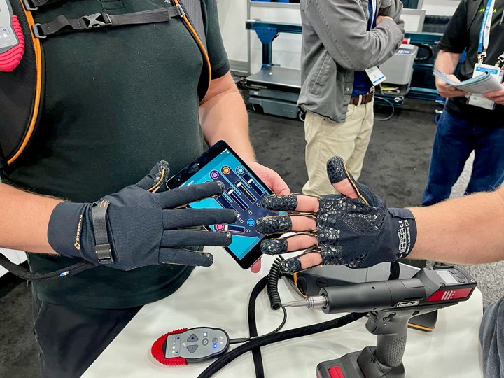 Two hands wearing black robotic grip-strengthening gloves from the company Ironhand