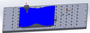 A simulated tool path for the surfacing operation on a machining center developed in CAMWorks. Updating this tool path when the cushion's contours are modified is virtually automatic.