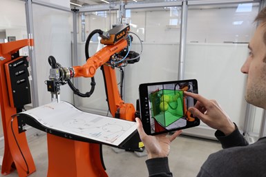 A person using a tablet to control a robot