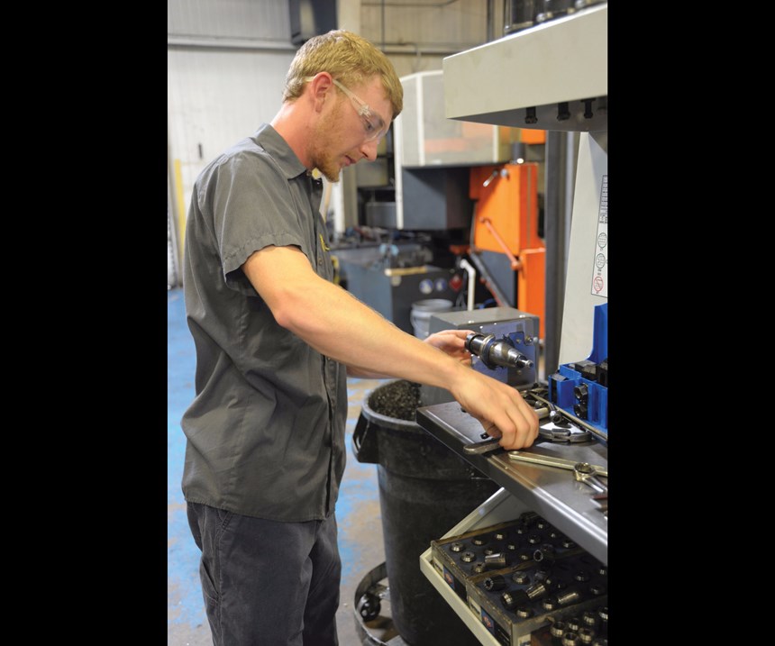 apprentice Hoke Durham works on a CNC setup
