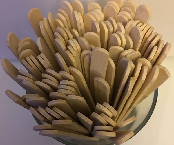 popsicle sticks in a glass cup