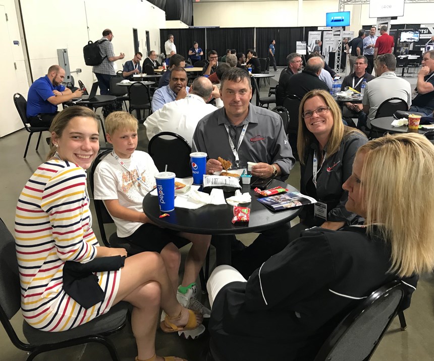 Maximum Mold owner and family members in seating area at Amerimold 2018