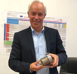DME President Peter R. Smith holding new Cooled Gate Bushing