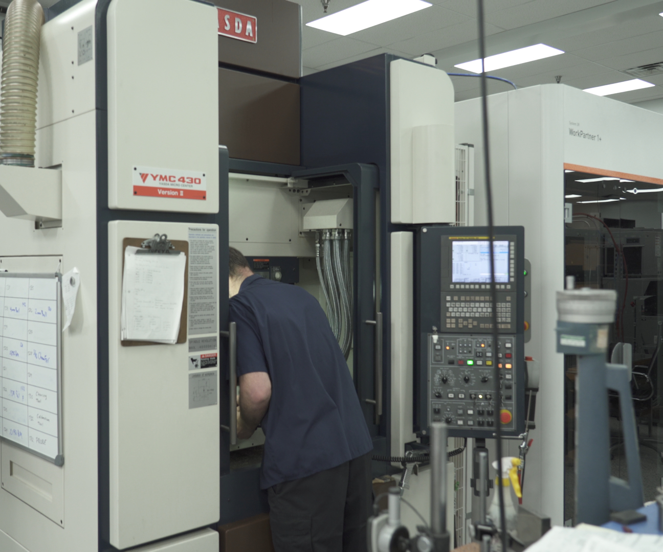 An X-Cell Tool and Mold team member sets up a Yasda for lights-out machining.