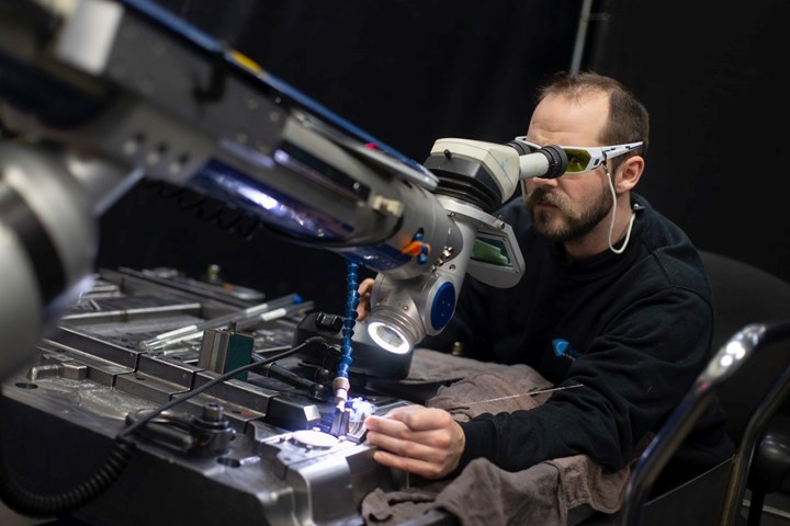 Eric Caron works on a laser welder at Cavalier Tool & Manufacturing 
