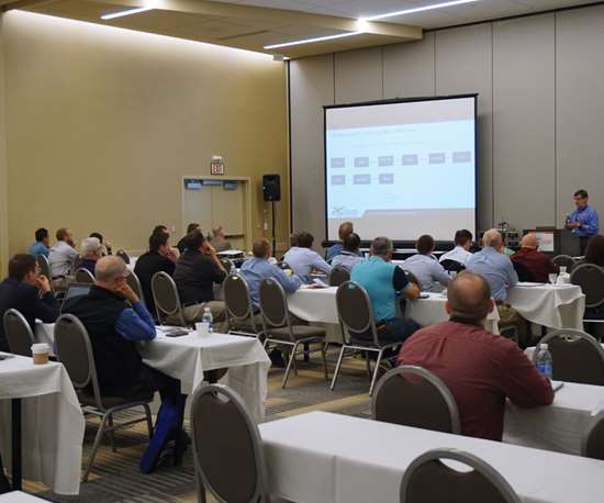 Attendees listen to a presentation during a conference session at the 2017 Parts Cleaning Expo.