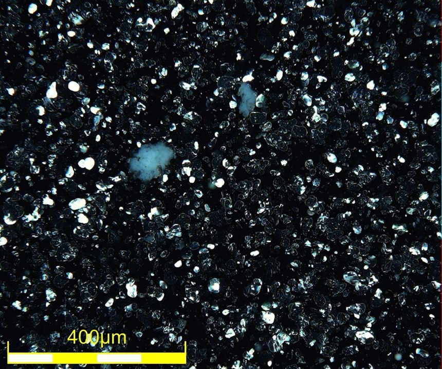 Clearcoat contamination under directional darkfield—277x, DSX510 microscope.