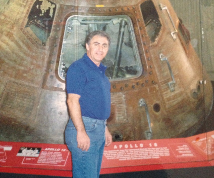 man in front of Apollo 16 module