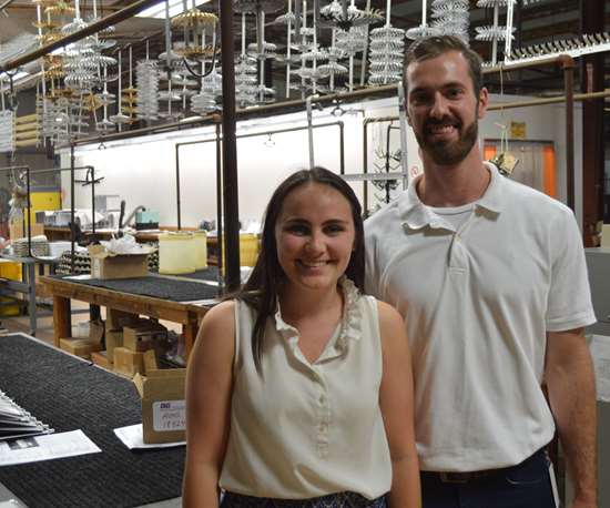 man and woman standing in a plating shop