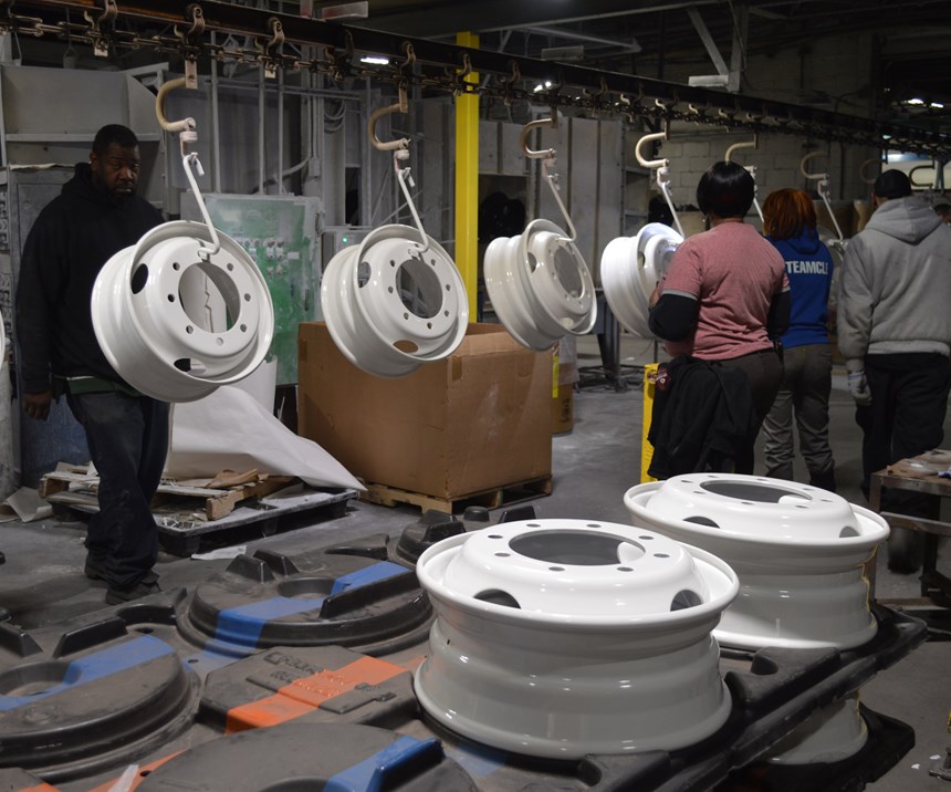 powder coated truck wheels on an assembly line