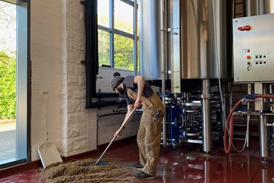 A photo of a Howard Town Brewery employee cleaning the brewery