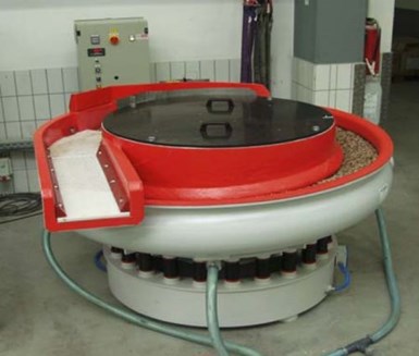 A traditional vibe bowl with parts/media separation deck; ideal for processing short stubby parts such as gears, tappets and bearings.	Figure 5 - A traditional vibratory tub; ideal for processing long skinny parts such as splined-shafts, camshafts, crankshafts, pinion shafts, spars, etc.