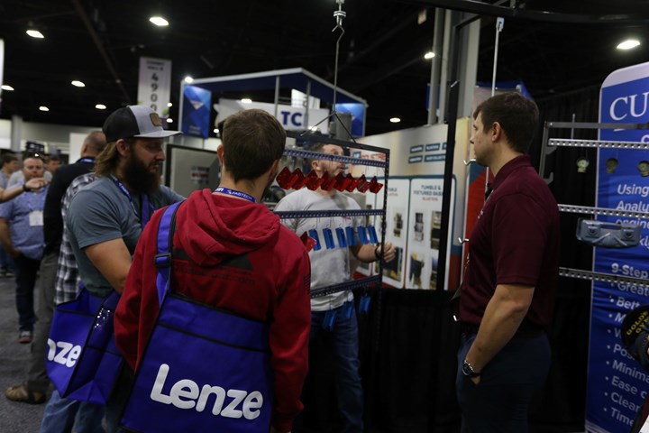 men gathered a booth at FABTECH 2022