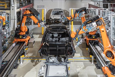 Robots remove paint defects in an automotive facility