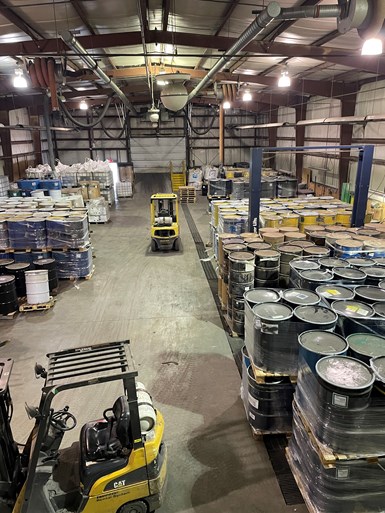 Overhead shot of warehouse showing pallets filled with barrels and boxes