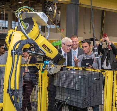 Governor Tony Evers checks out an industrial robot 