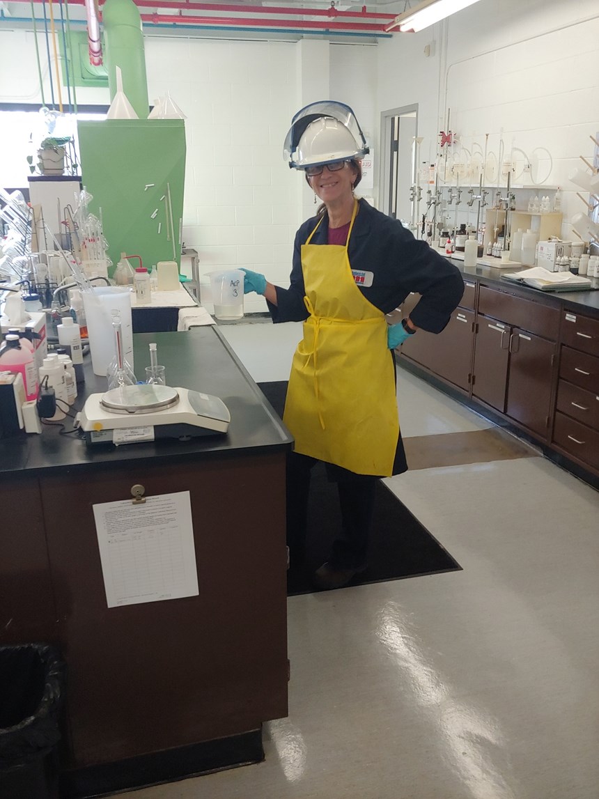 women with hard hat in lab