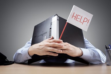 man with laptop over his head holding 