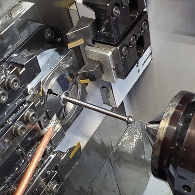 driveshaft being machined on a Swiss-type lathe