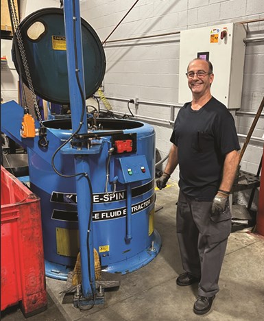 A person stanking next to a tank
