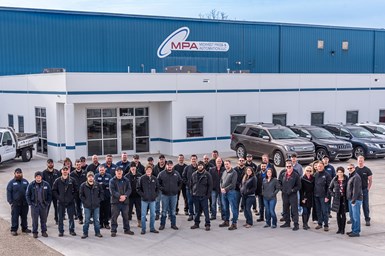 The company's team in front of its facility.