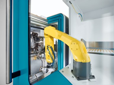 Image of yellow robotic arm inside a turn mill