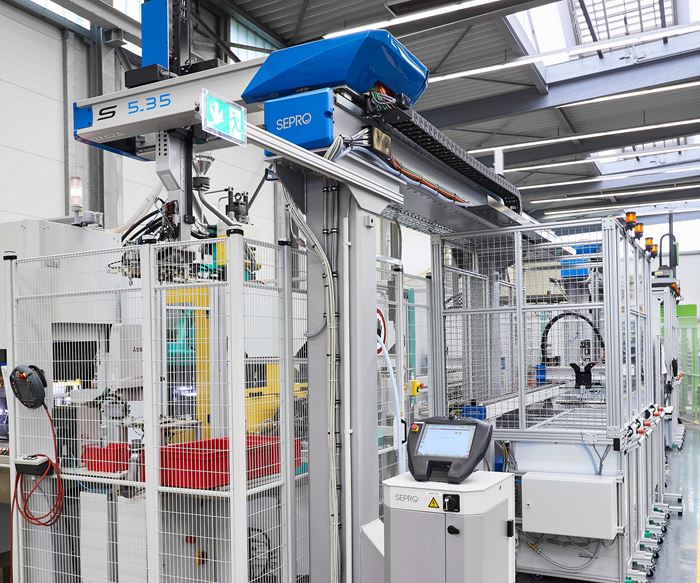 Two injection molding cells each include three Sepro linear robots operating together with Arburg vertical injection molding machines.