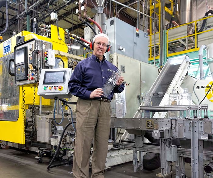 Meredith-Springfield president and CEO Mel O’Leary holds a large EPET jar molded on a Bekum extrusion blow molding machine